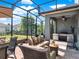 Covered patio with stainless grill, outdoor seating, and screened in section at 987 Nathan Ridge Rd, Clermont, FL 34715