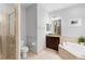 Clean bathroom with a soaking tub, glass shower, and vanity with a granite countertop at 10430 Belfry Cir, Orlando, FL 32832