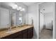 Bathroom with granite countertops, double sinks, cabinets, walk-in shower, and a linen closet at 10430 Belfry Cir, Orlando, FL 32832