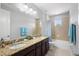 Bathroom with granite countertops, double sinks, cabinets, walk-in shower and tub combo at 10430 Belfry Cir, Orlando, FL 32832
