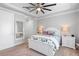Relaxing bedroom features a white bedframe, neutral carpet, and a large mirror to reflect natural light at 10430 Belfry Cir, Orlando, FL 32832