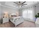 Comfortable bedroom features large windows with white curtains, a ceiling fan, and two bedside lamps at 10430 Belfry Cir, Orlando, FL 32832