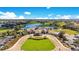 Elegant clubhouse surrounded by a meticulously maintained golf course and scenic lake at 10430 Belfry Cir, Orlando, FL 32832