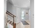 Inviting entryway with a staircase, decorative vase, tiled floor, and a front door with decorative glass at 10430 Belfry Cir, Orlando, FL 32832