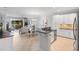 Open kitchen connects to the dining area, featuring stainless appliances, granite countertops, and tile flooring at 10430 Belfry Cir, Orlando, FL 32832