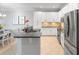 This large kitchen is equipped with stainless appliances, stone countertops, white cabinets, and a tile floor at 10430 Belfry Cir, Orlando, FL 32832