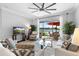 Bright living room with neutral tones, ceiling fan, and sliding doors to the outdoor patio with lake views at 10430 Belfry Cir, Orlando, FL 32832