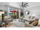 Cozy living room featuring a ceiling fan, neutral furniture, and sliding glass doors to a screened patio at 10430 Belfry Cir, Orlando, FL 32832