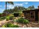 Manicured backyard featuring lush landscaping and a cozy screened-in patio at 105 Oaks Ct, Sanford, FL 32771