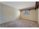 Neutral bedroom showcasing a sunlit window and neutral carpet at 105 Oaks Ct, Sanford, FL 32771