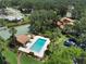 Aerial view of a community pool and tennis courts surrounded by lush landscaping at 105 Oaks Ct, Sanford, FL 32771