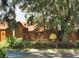 A stone and brick community sign for The Oaks, with a golden tree logo and lush landscaping at 105 Oaks Ct, Sanford, FL 32771