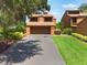 Two-story home with a two-car garage, driveway and a neatly manicured lawn at 105 Oaks Ct, Sanford, FL 32771