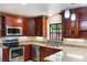 Kitchen with stainless steel appliances, wood cabinets, light countertops, and under cabinet lights at 105 Oaks Ct, Sanford, FL 32771