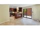 Open kitchen with stainless steel appliances, granite countertops, island, and sliding glass doors at 105 Oaks Ct, Sanford, FL 32771