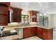 Well-lit kitchen featuring stainless steel appliances, granite countertops and dark wood cabinetry at 105 Oaks Ct, Sanford, FL 32771