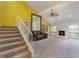 Bright living room with fireplace, fan, adjacent stairs, sofa and window views at 105 Oaks Ct, Sanford, FL 32771