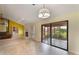 Bright living room with fireplace, fan, adjacent stairs, sofa and window views to enclosed porch at 105 Oaks Ct, Sanford, FL 32771