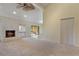 Spacious living room with stone fireplace, fan, neutral carpet, and access to back porch at 105 Oaks Ct, Sanford, FL 32771