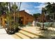 Outdoor pool deck featuring lounge chairs, tables, umbrellas, and shade trees at 105 Oaks Ct, Sanford, FL 32771