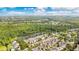 Beautiful aerial view of a community nestled among lush trees next to a large pond, with a view of the city at 1222 Golden Canna Ln, Celebration, FL 34747
