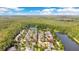 Beautiful aerial view of a community nestled among lush trees next to a large pond, with a view of the city at 1222 Golden Canna Ln, Celebration, FL 34747