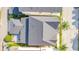 Aerial view of home with dark roof, green lawns, and shaded street at 1222 Golden Canna Ln, Celebration, FL 34747