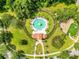 Overhead shot of community pool, playground, surrounded by green spaces and trees at 1222 Golden Canna Ln, Celebration, FL 34747