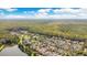 Beautiful aerial view of a community nestled among lush trees next to a large pond, with a view of the city at 1222 Golden Canna Ln, Celebration, FL 34747