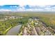 Beautiful aerial view of a community nestled among lush trees next to a large pond, with a view of the city at 1222 Golden Canna Ln, Celebration, FL 34747