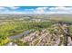 Beautiful aerial view of a community nestled among lush trees next to a large pond, with a view of the city at 1222 Golden Canna Ln, Celebration, FL 34747