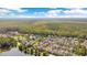 Beautiful aerial view of a community nestled among lush trees next to a large pond, with a view of the city at 1222 Golden Canna Ln, Celebration, FL 34747