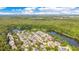 Beautiful aerial view of a community nestled among lush trees next to a large pond, with a view of the city at 1222 Golden Canna Ln, Celebration, FL 34747
