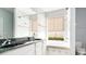 Bright bathroom with double vanity, granite countertop, and a window-side tub at 1222 Golden Canna Ln, Celebration, FL 34747