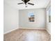 Bright bedroom with hardwood floors, a ceiling fan, and a window providing natural light at 1222 Golden Canna Ln, Celebration, FL 34747