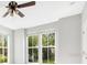 Light-filled bedroom boasts a ceiling fan and two large windows with green outdoor views at 1222 Golden Canna Ln, Celebration, FL 34747