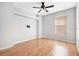 Open bedroom featuring hardwood floors, a modern ceiling fan, and a window at 1222 Golden Canna Ln, Celebration, FL 34747