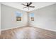 Bedroom features hardwood floors, ceiling fan and two large windows at 1222 Golden Canna Ln, Celebration, FL 34747