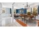 Bright dining room featuring an elegant chandelier, light walls, and adjacent living area at 1222 Golden Canna Ln, Celebration, FL 34747