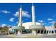 Unique architectural design showcasing prominent towers against a bright blue sky at 1222 Golden Canna Ln, Celebration, FL 34747