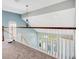 Hallway featuring wood and white railing with gray carpet at 1222 Golden Canna Ln, Celebration, FL 34747