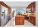 Bright kitchen with stainless steel appliances, granite counters, wood cabinets and kitchen island at 1222 Golden Canna Ln, Celebration, FL 34747