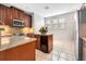 Wood cabinet kitchen features granite countertops, stainless appliances and an island with built-in wine cooler at 1222 Golden Canna Ln, Celebration, FL 34747