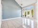 Spacious living room with a high ceiling, ample natural light, and tiled flooring at 1222 Golden Canna Ln, Celebration, FL 34747