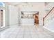 Bright living space with tile floors, windows, and a view of the kitchen and staircase at 1222 Golden Canna Ln, Celebration, FL 34747