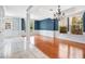 Spacious living room boasting hardwood floors, natural light, and an elegant chandelier at 1222 Golden Canna Ln, Celebration, FL 34747