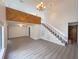 Spacious living room with a vaulted ceiling, wooden beams, staircase, and modern wood-look floors at 1288 Se 32Nd St, Ocala, FL 34471