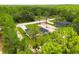 Modern residence nestled among tall trees, featuring a driveway and verdant grass, with another house nearby at 13619 Sw 78Th Place, Dunnellon, FL 34432