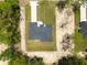 An aerial view shows the house and surrounding property with clear property lines and tree coverage at 13619 Sw 78Th Place, Dunnellon, FL 34432