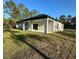 A covered patio extends from the rear of this home into a spacious yard at 13619 Sw 78Th Place, Dunnellon, FL 34432